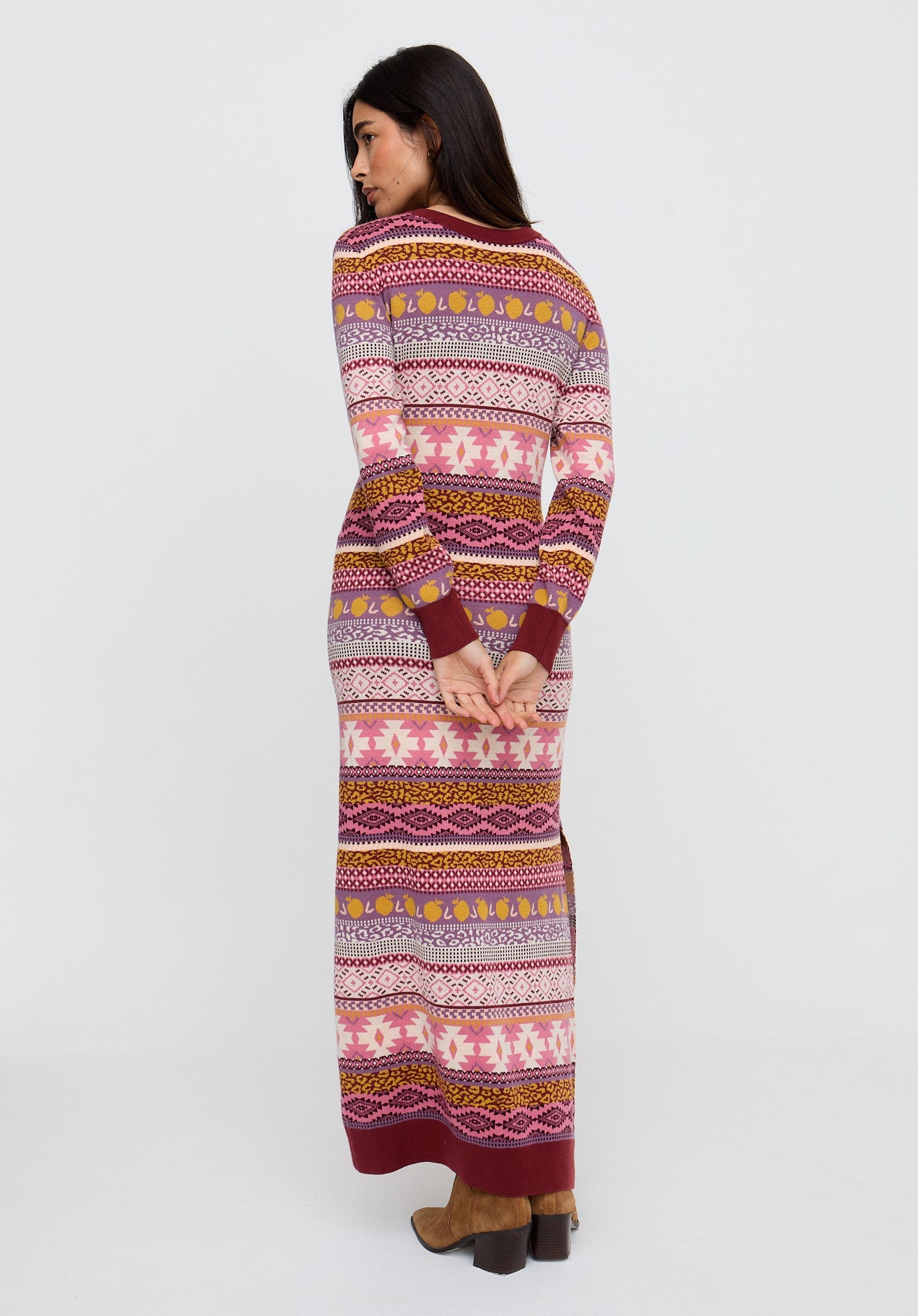 Woman wearing a patterned long dress on a white background