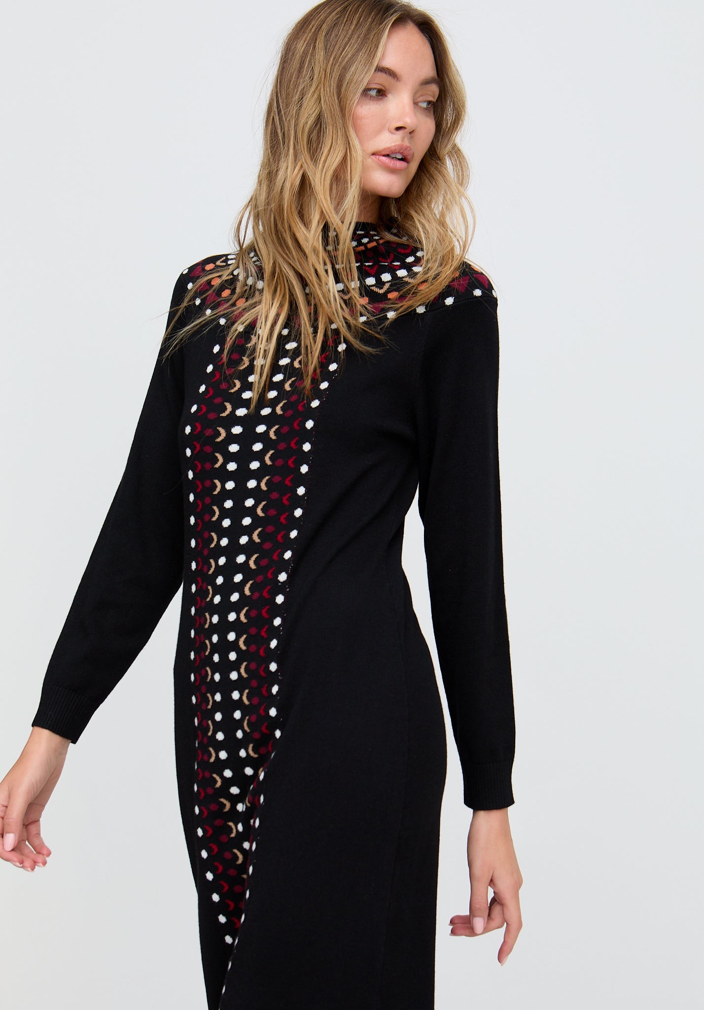 Woman wearing a black dress with a patterned scarf on a white background
