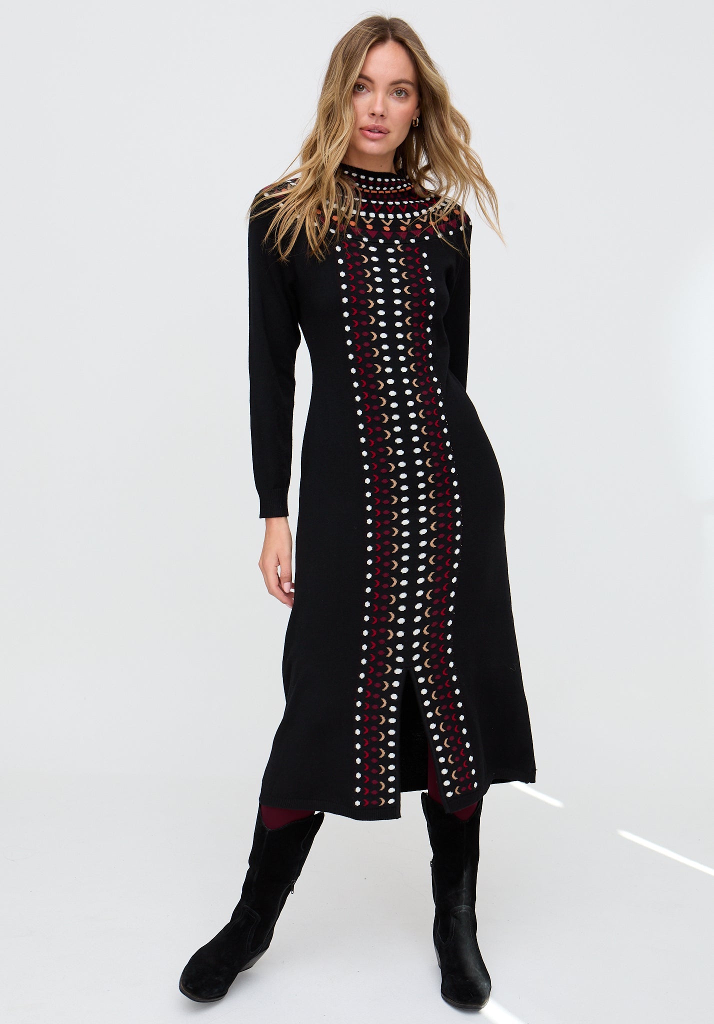 Woman wearing a black dress with a patterned design on a white background