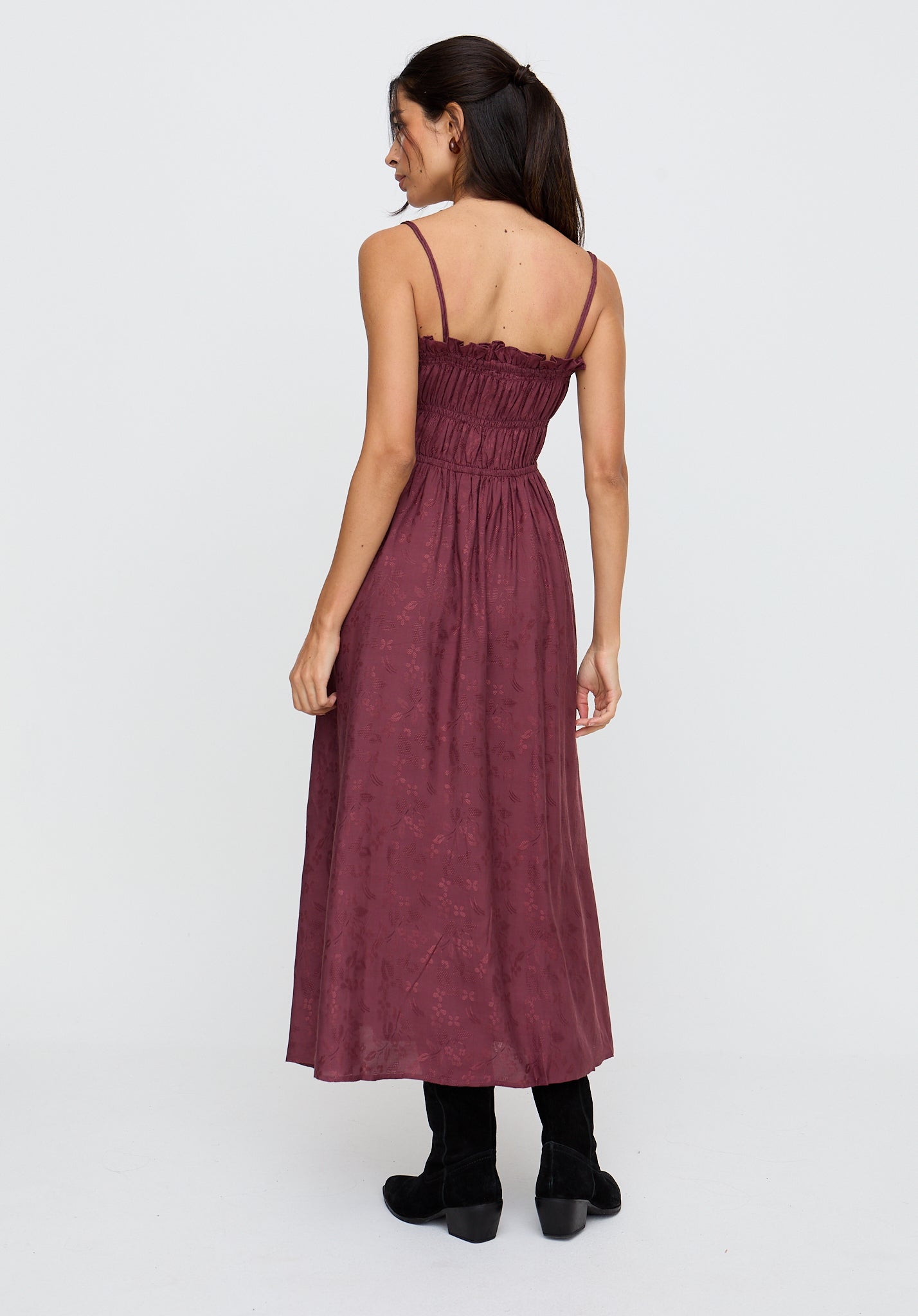 Woman wearing a burgundy dress on a white background