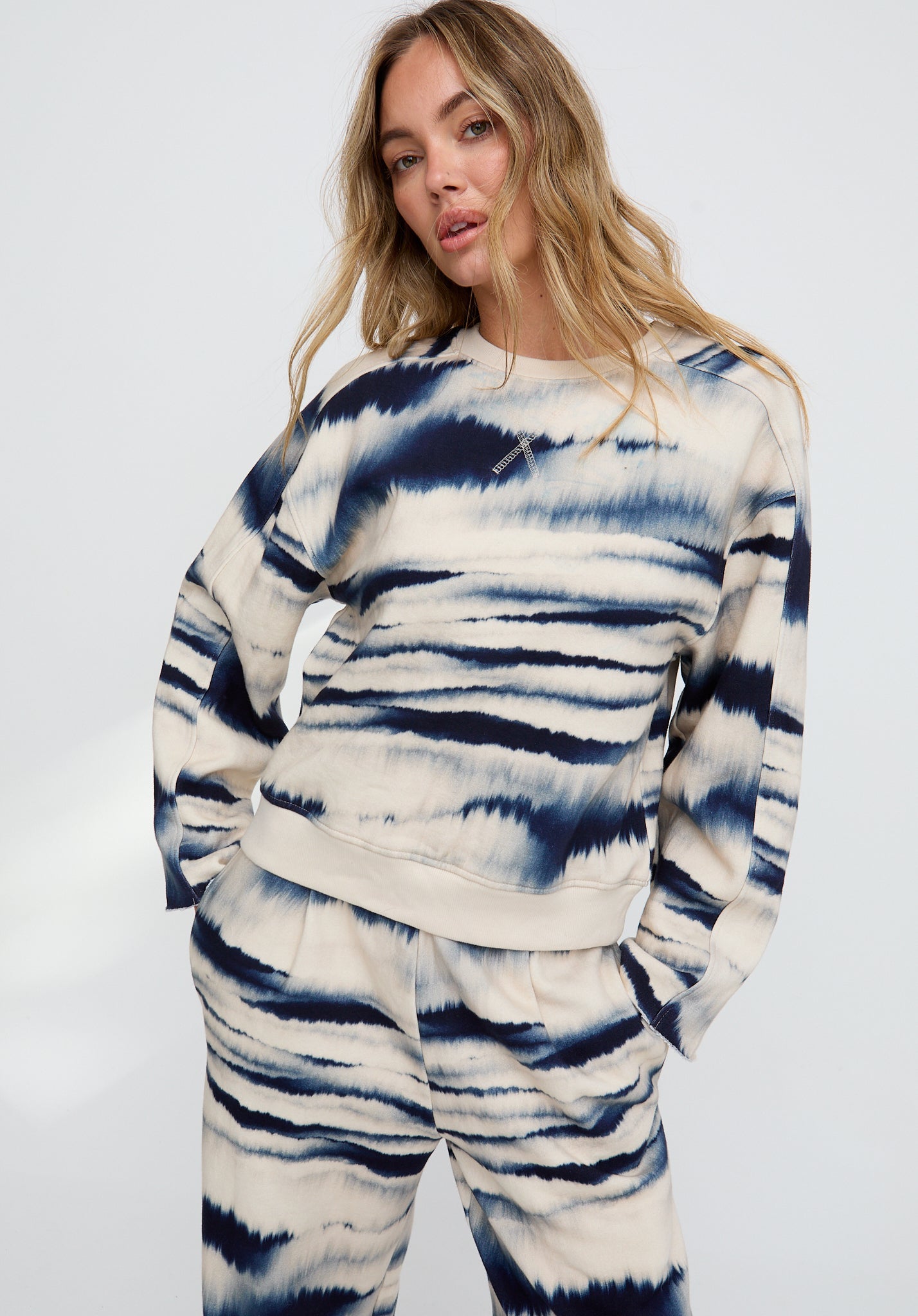 Woman wearing a tie-dye outfit on a white background