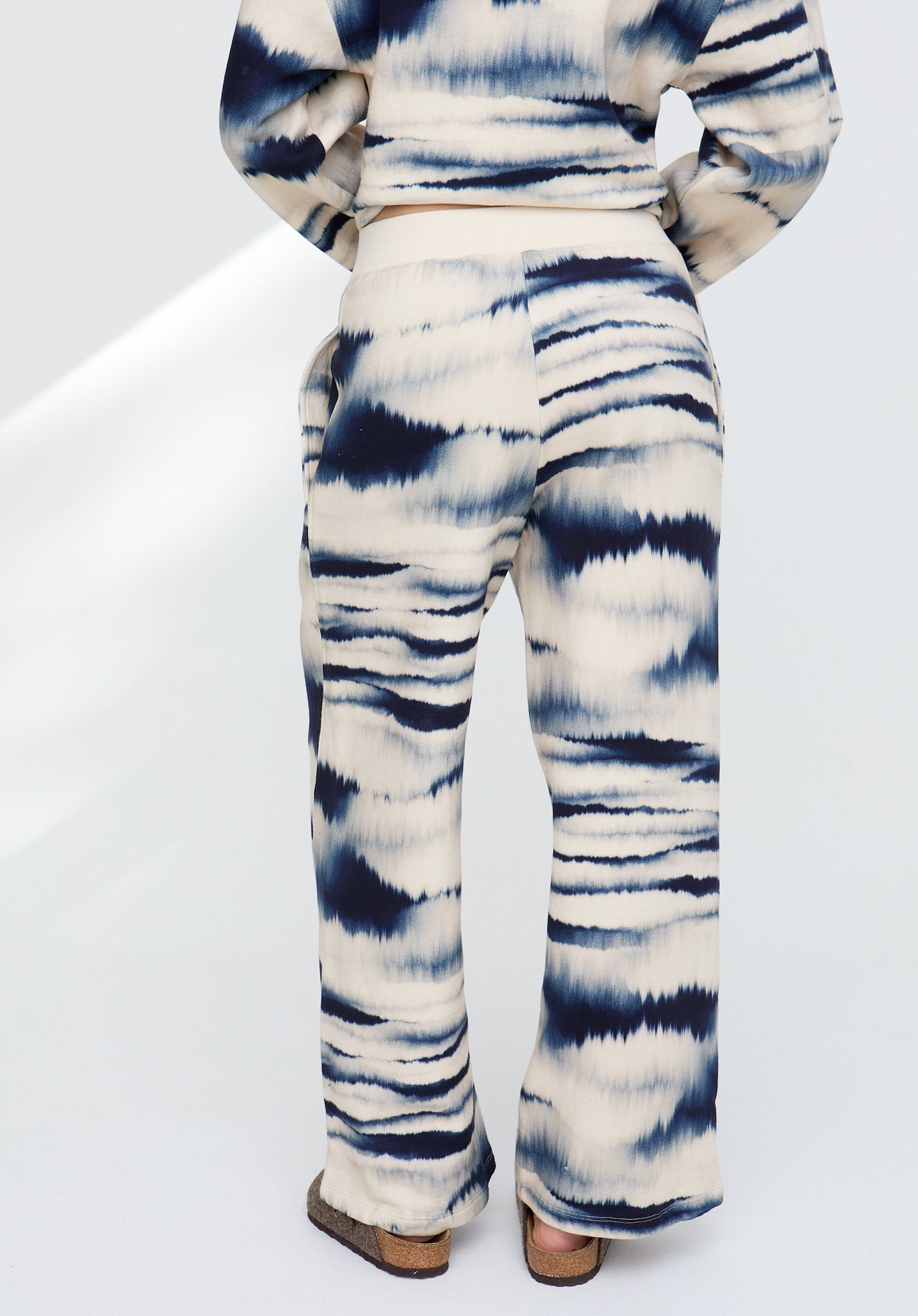 Tie-dye outfit with a pattern of blue and white on a white background