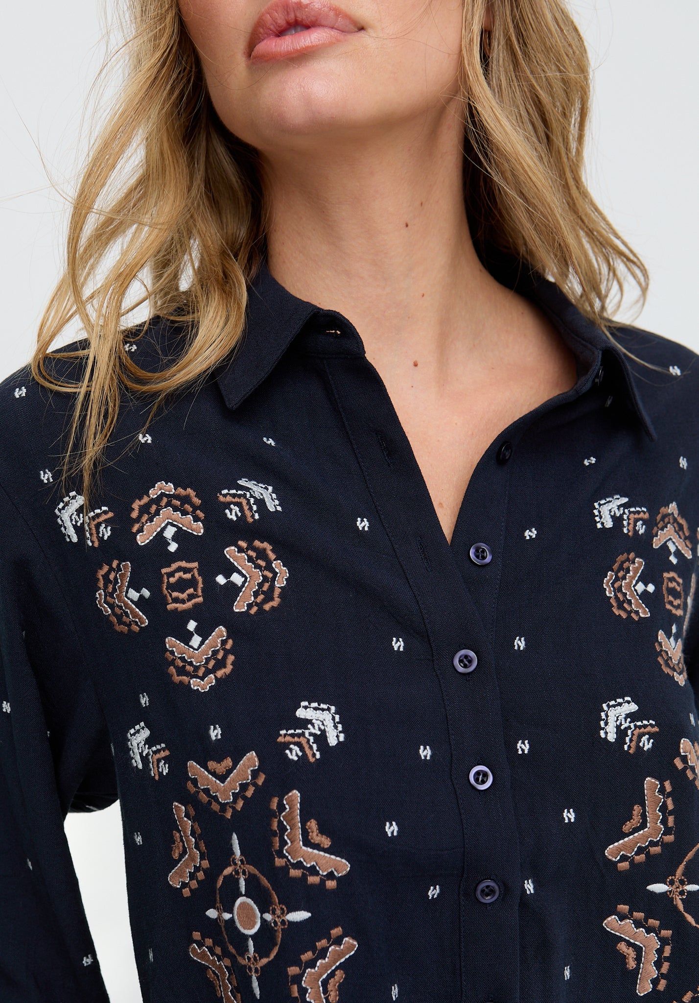Navy blue shirt with intricate patterns worn by a person