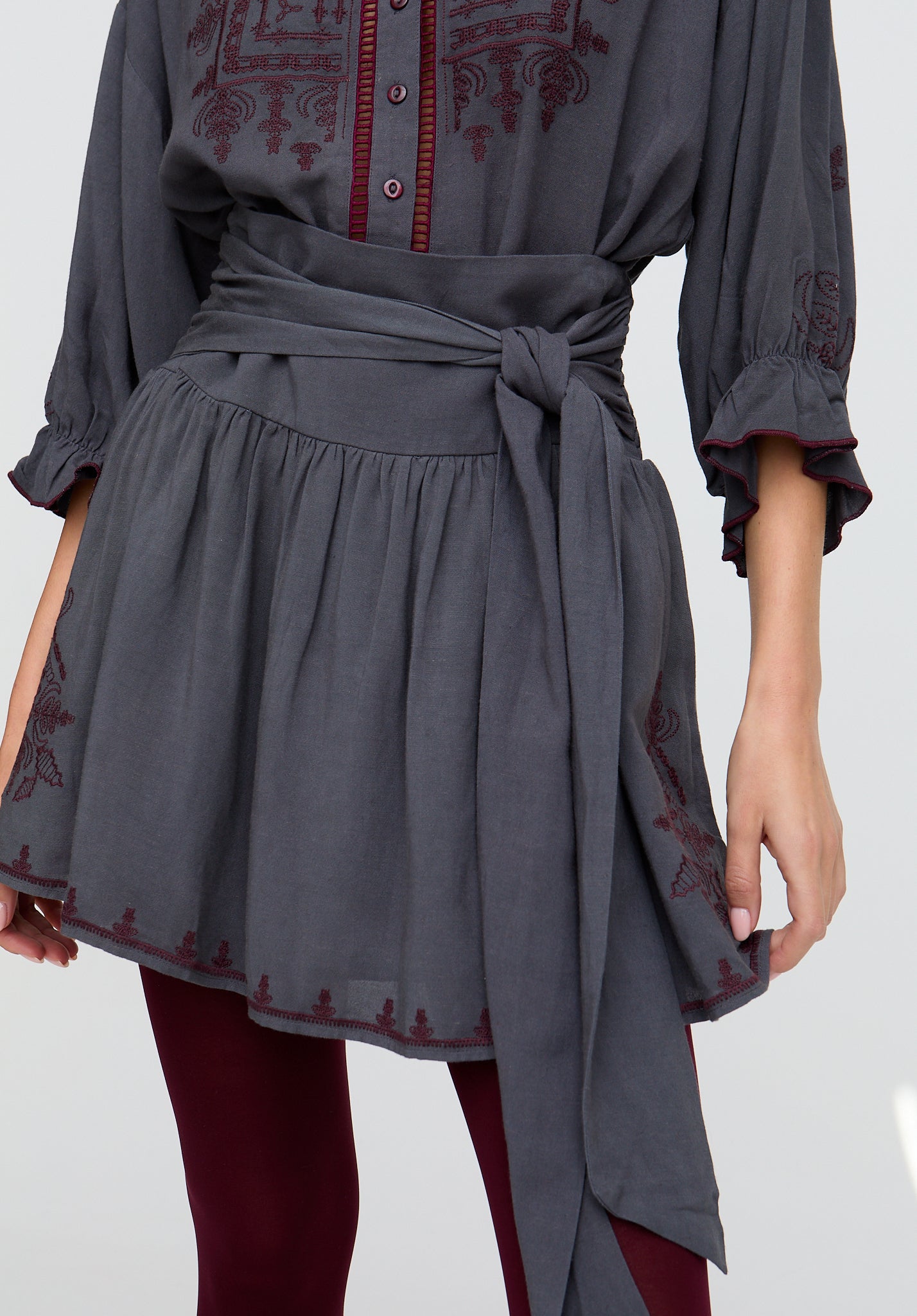 Gray dress with red embroidery on a white background